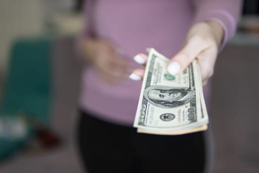 man holds out dollars close-up. High quality photo