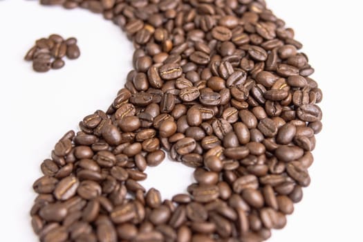 yin yang sign made by coffee beans on white background,macro shooting. High quality photo