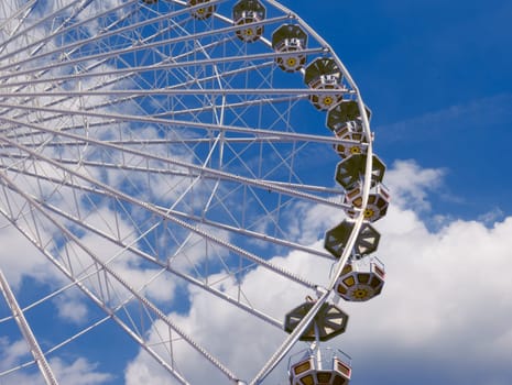 Ferris wheel in the park, a close-up view from the bottom against the blue sky. there is a place for the inscription.Ferris wheel close-up on the booths. High quality photo