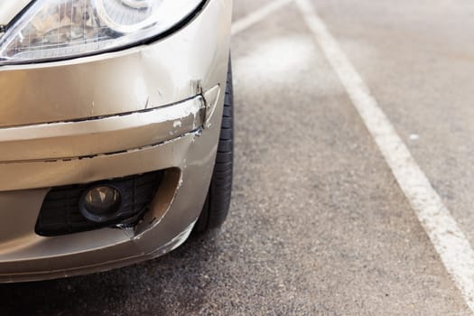 Car bumper scratched with deep paint damage. Dent scratch car. Broken car in an accident. there is a place for an inscription on the right side. High quality photo