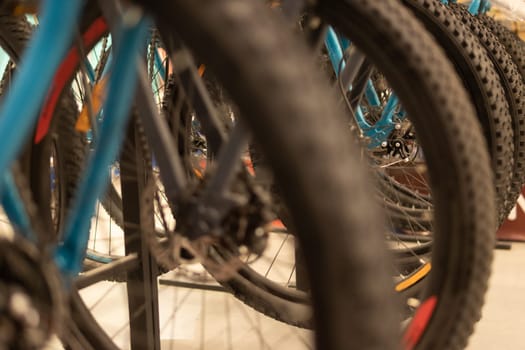 Wheels from a bicycle close-up. A lot of bicycles in the store. High quality photo