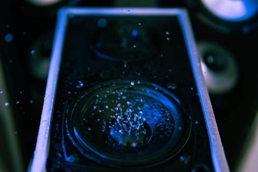 Water movement on the loudspeaker. The power of sound. Abstract movement. Loud music. Music and movement. High quality photo