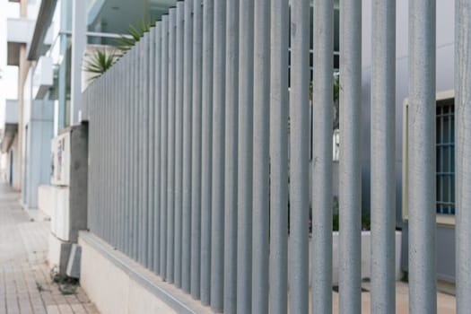 gray metal fence along the road close-up. there is a place for an inscription. High quality photo