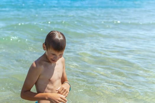 Happy boy swims and dives underwater. Active healthy lifestyle, water sports and activities with parents on summer family vacation with child. High quality photo