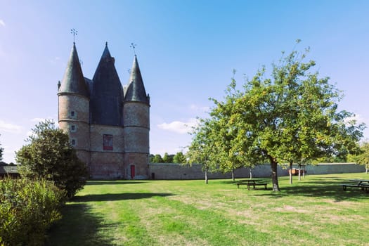 an old castle in France, around the castle green grass and trees grow on a large plot there is a place for an inscription, a beautiful landscape and background. High quality photo