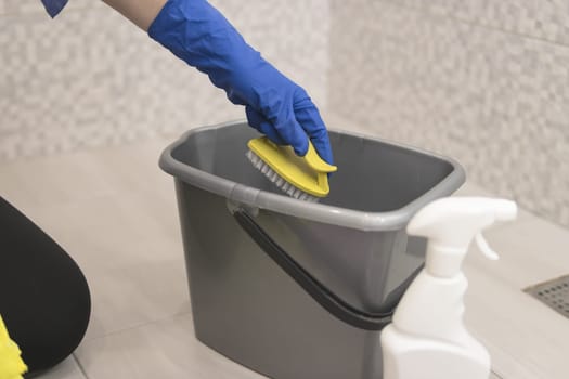 cleaning the bathroom girls hands in blue gloves cleaning concept. High quality photo