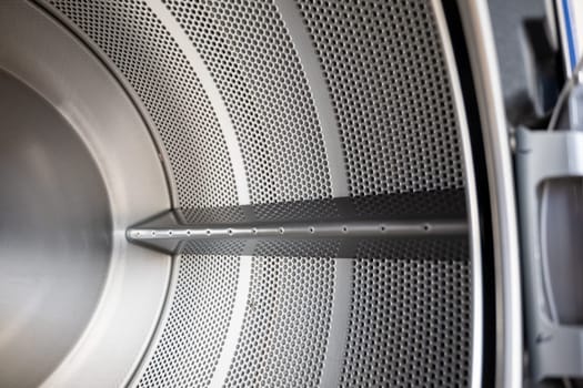 Close up Inside of washing machine tub with opened door is made of stainless steel, brand new drum material metal electrical household appliance, Empty inside