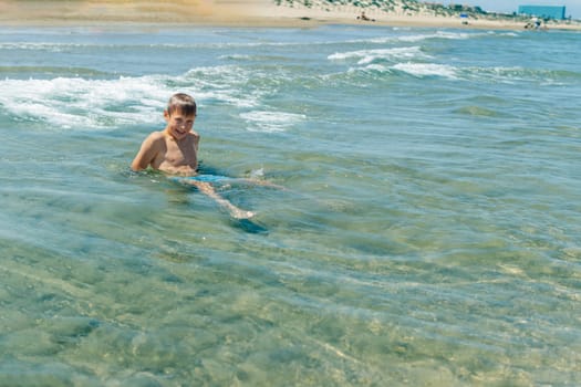 Happy boy swims and dives under water Active healthy lifestyle, water sports, seascape with a child there is a place for an inscription. High quality photo