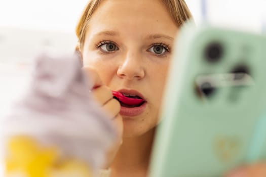 teenage girl eats purple ice cream, the focus on the ice cream background is blurred, there is a place for the inscription. High quality photo