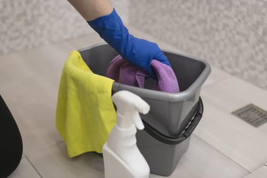 cleaning the bathroom girls hands in blue gloves cleaning concept. High quality photo