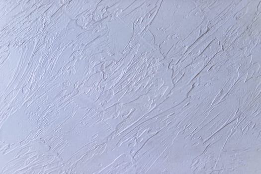 texture of decorative plaster of light color. New gray plaster on the wall close-up Colorful wavy abstract pattern.wall texture background and copy space for text