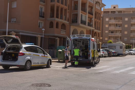 Spain, Torrevieja May 28, 2023, an ambulance on the road picks up a man who was hit by a car on the road, a resort town in Spain near the sea. High quality photo