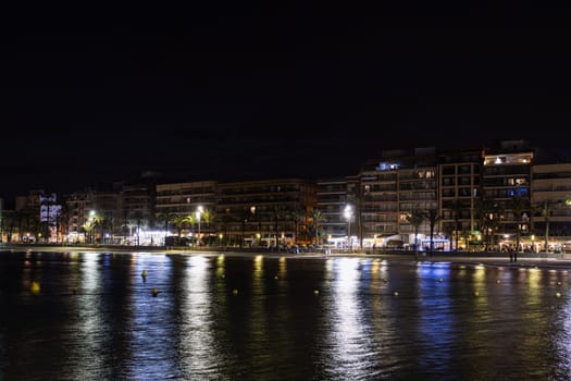 Asphalt road and city skyline with modern building at night . sea evening landscape High quality photo