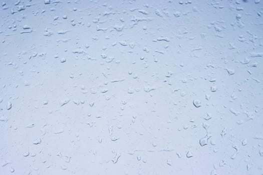 Drops of water on a light texture background. the background glass is covered with water drops. bubbles. High quality photo