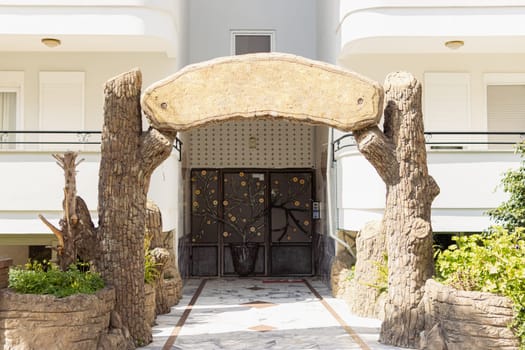 entrance to the hotel, at the entrance there is a wooden structure with a place for your inscription. High quality photo