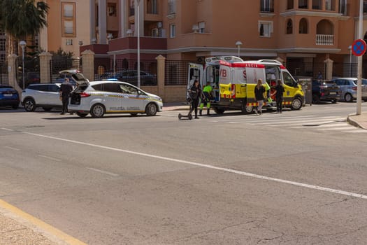 Spain, Torrevieja May 28, 2023, an ambulance on the road picks up a girl who was hit by a car on the road,. High quality photo