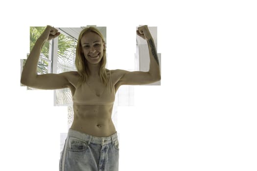 a happy girl of European appearance stands in a house in big jeans and shows the result of losing weight and proper nutrition.healthy lifestyle concept. PNG High quality photo