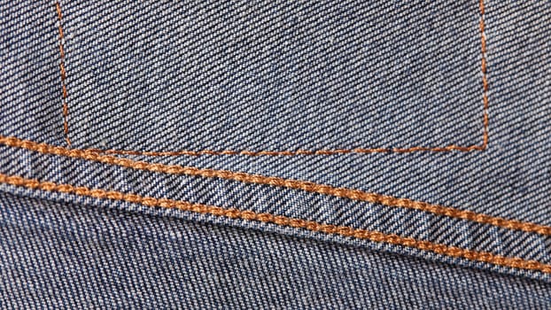 Seams on jeans close-up in high-resolution. Stitching on denim on the inside. Fabric texture. Blue jeans background and texture. Denim texture on the underside of the textile.
