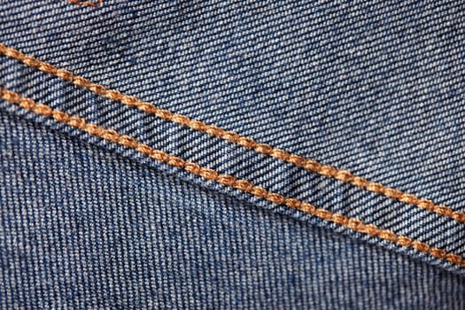 Seams on jeans close-up in high-resolution. Stitching on denim on the inside. Fabric texture. Blue jeans background and texture. Denim texture on the underside of the textile.