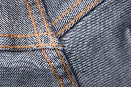 Seams on jeans close-up in high-resolution. Stitching on denim on the inside. Fabric texture. Blue jeans background and texture. Denim texture on the underside of the textile.
