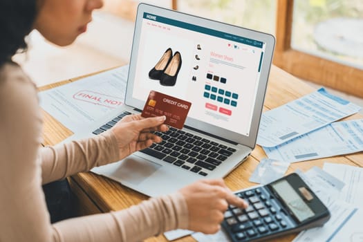 Woman shopping online on internet marketplace browsing for sale items for modern lifestyle and use credit card for online payment from wallet protected by crucial cyber security software