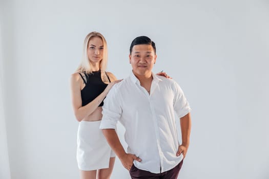 man and a woman in love couple pose on a white background
