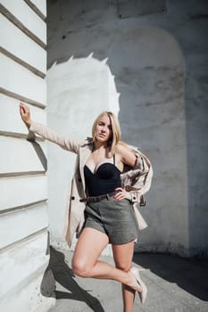 a fashionable blonde woman at the textured wall