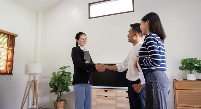 Couple asian handshake with a real estate agent after purchase a home.