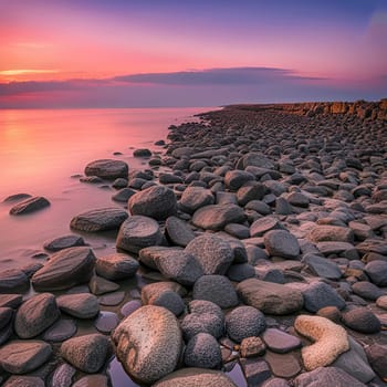 Sunset over the sea with stones on the foreground. Reflections.Sunset over the sea with stones in the foreground and reflection in water.