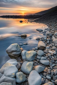 Sunset over the sea with stones on the foreground. Reflections.Sunset over the sea with stones in the foreground and reflection in water.