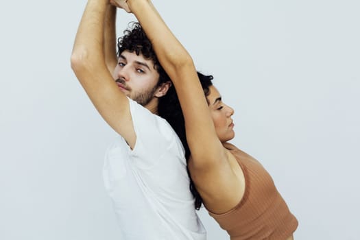 a woman and man do yoga stretching exercises in the gym