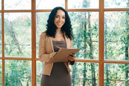 Psychologist woman in clinic office professional portrait with friendly smile feeling inviting for patient to visit the psychologist. The experienced and confident psychologist is crucial specialist