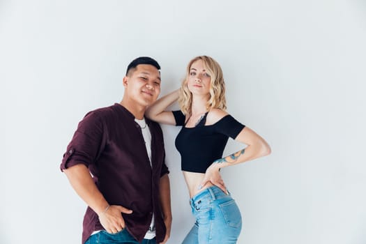 couple of lovers pose together standing on a white background