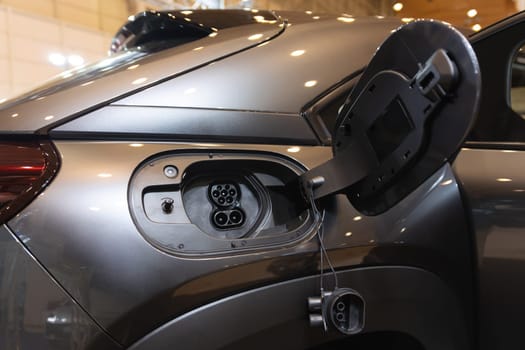 An electric car is being charged at a charging station