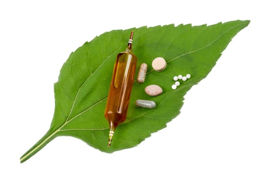 Alternative medicine, naturopath and dietary supplement. Herbal remedy in capsules and plants over white