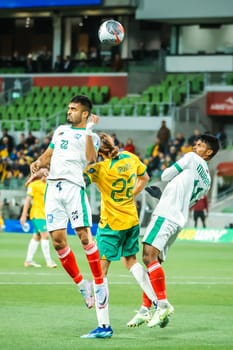 MELBOURNE, AUSTRALIA - NOVEMBER 16: Jackson Irvine of Australia and Saad Uddin of Bangladesh compete for a header during the 2026 FIFA World Cup Qualifier match between Australia Socceroos and Bangladesh at AAMI Park on November 16, 2023 in Melbourne, Australia