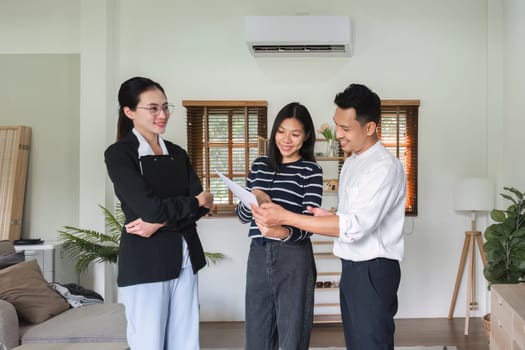 Real estate agents present and advise clients in deciding whether to sign a home sales agreement form or insure about offering mortgage loans and home insurance..