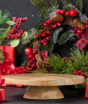 Empty round wooden platform for displaying products in the middle of Christmas decor