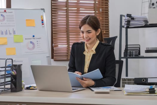 Business woman using calculator for do math finance on wooden desk in office and business working background, tax, accounting, statistics and analytic research concept..