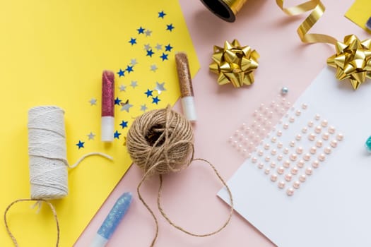 Christmas rustic flat lay. Stylish wrapping paper, wooden reindeer, pine branches and cones, scissors, thread on rural wooden table, copy space. Seasons greeting card mockup