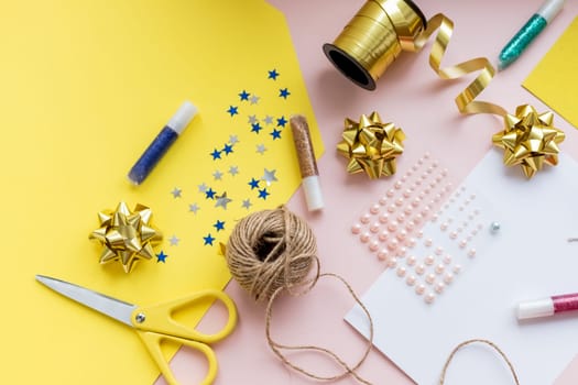 Christmas rustic flat lay. Stylish wrapping paper, wooden reindeer, pine branches and cones, scissors, thread on rural wooden table, copy space. Seasons greeting card mockup