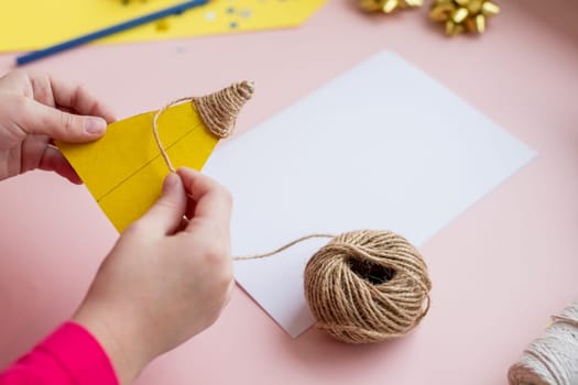 the child makes a New Year card for the winter holidays. DIY crafts and crafts for Christmas do-it-yourself concept