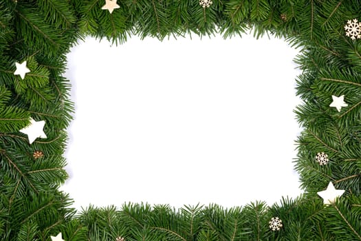 Christmas border arranged with fresh fir branches and wooden decor isolated on white background , copy space for text