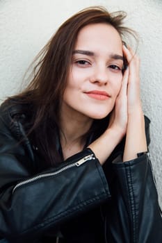 portrait of woman in leather clothes on a light background