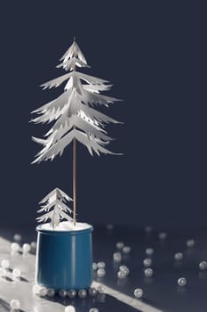 Christmas tree made of paper on a gray background. The concept of an alternative Christmas tree