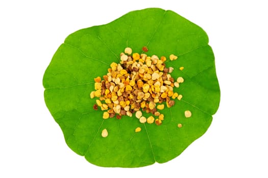 Macro shot of bee pollen on green nasturtium leaf white background. Raw brown, yellow, orange and blue flower pollen.