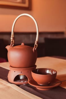 A tea set made of a teapot and a cup made of clay. Tea ceremony