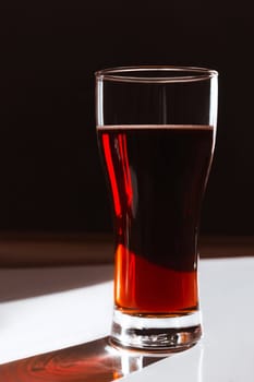 Refreshing drink kvass, beer in a high transparent glass on a black and white background