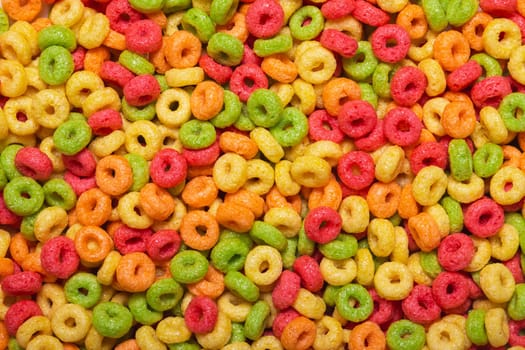Colored sweet corn rings for the whole frame close-up. A quick, fun and healthy breakfast for children