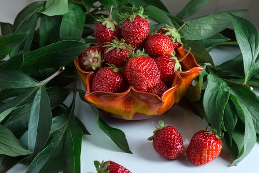 Ripe red strawberries. Berry in a orange vase